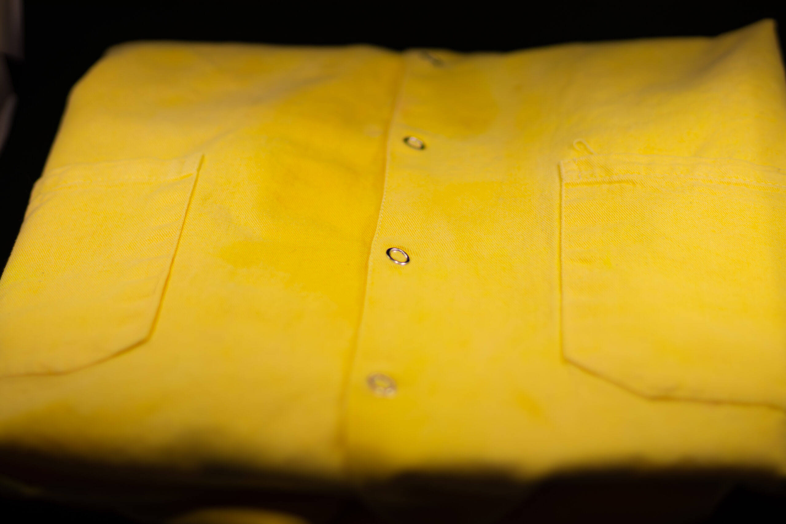 Angled photo depicting the snap buttons of the Indicator Labcoat